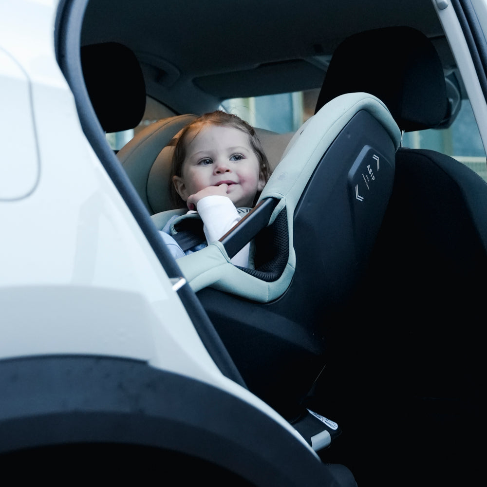 Axkid Spinkid 2 Car Seat Nordic Bloom Green Baby in white car