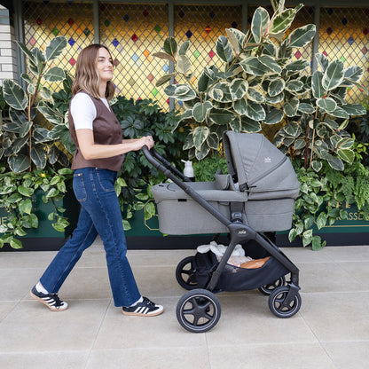 Mum pushing Joie Finiti Pram with Rable XL Carrycot Evergreen